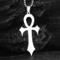 A silver Ankh pendant necklace on a chain, shown against a dark textured background.