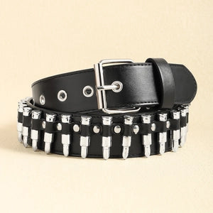 A black leather belt with silver metal studs and a silver buckle, coiled on a light beige background.