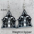 A pair of silver-toned triangular dangle earrings with a black and silver graphic design, shown against a white background with text indicating weight.