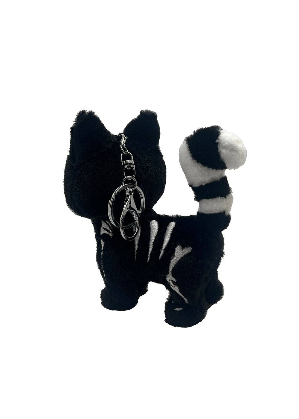 Black and white stuffed animal keychain with a keyring on a white background