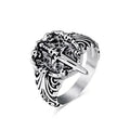 Silver ring with intricate design on a white background