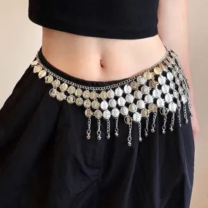 A close-up of a model's waist wearing a black hip scarf or belly dance skirt adorned with a wide, ornate silver coin belt featuring dangling chains and coin embellishments.