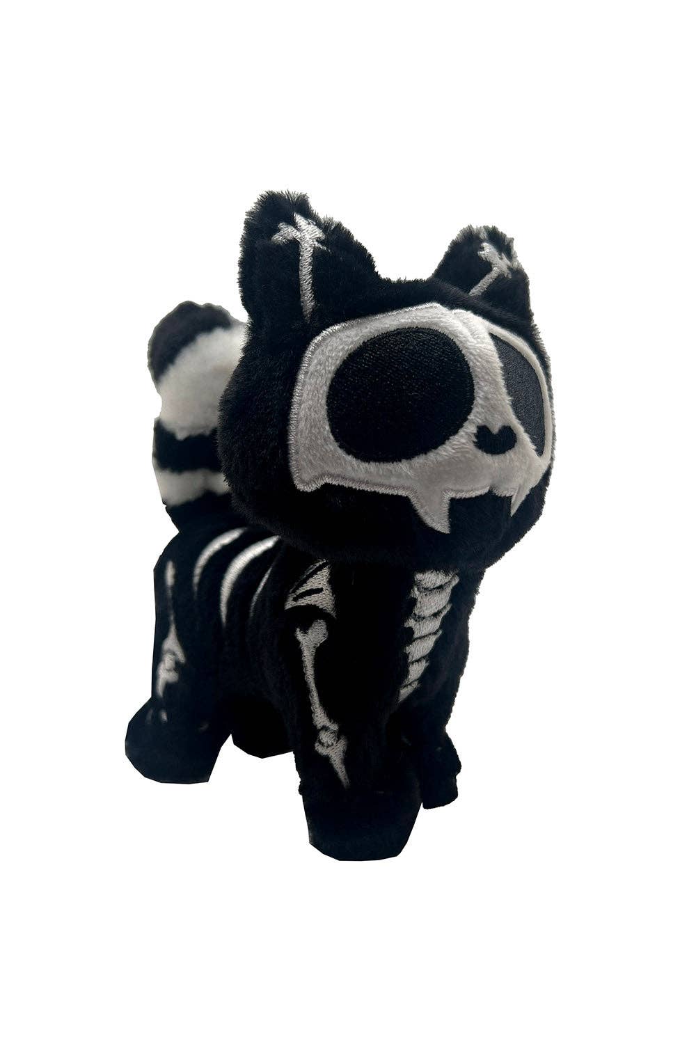 Black and white plush toy resembling a skeleton on a white background